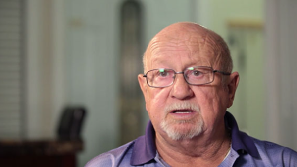 Alan is shown speaking to the camera