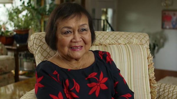 Didi is shown smiling in her living room