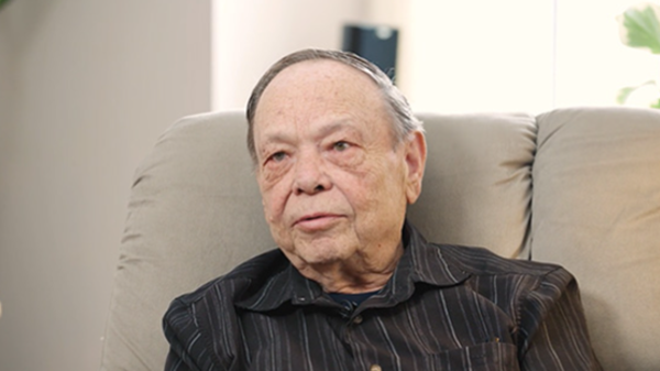 Tom is shown speaking