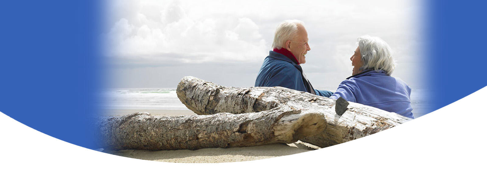 older couple sitting on the beach