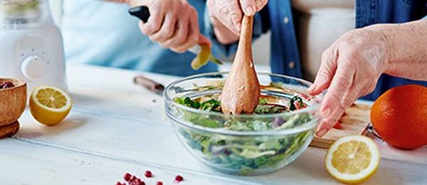 Patient and their spouse preparing a kidney-friendly salad together
